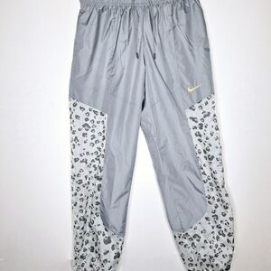 Nike brand "The Snow Leapard in a Jogger".Parachute Joggers size small.